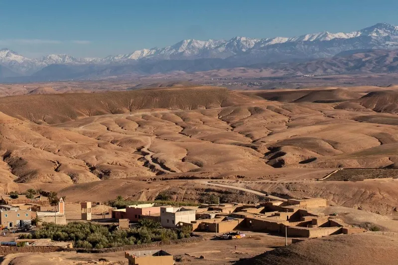 A panoramic view of Marrakech, Morocco, showcasing its vibrant architecture against the backdrop of the desert landscape.